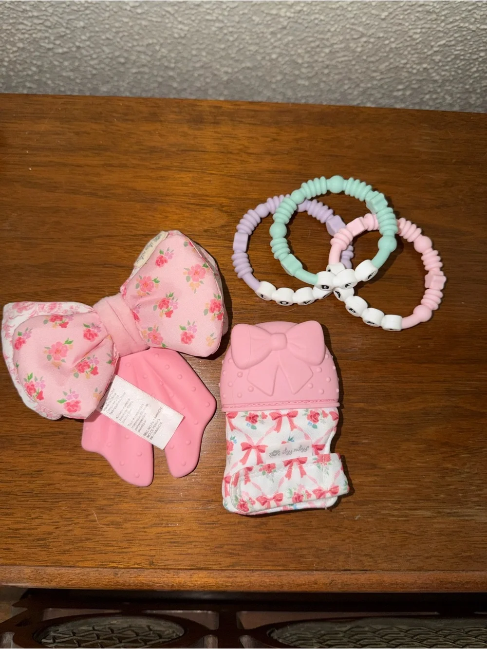 Itzy Ritzy Pink Floral Bow Teether, Floral Mitten, and Beaded teethers